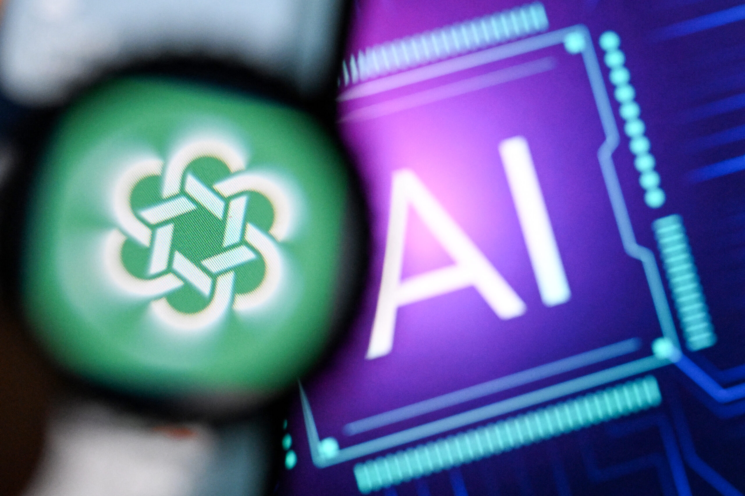 A photo taken on February 26, 2024 shows the logo of the ChatGPT application developed by US artificial intelligence research organization OpenAI on a smartphone screen (L) and the letters AI on a laptop screen in Frankfurt am Main, western Germany. (Photo by Kirill KUDRYAVTSEV / AFP)